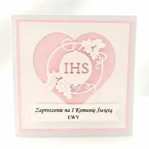 Zaproszenie na Pierwszą Komunię Świętą dla dziewczynki w kolorze różowym, z sercem i symbolem IHS, wykonane z papieru wizytówkowego, delikatne i dziewczęce zaproszenie komunijne.
