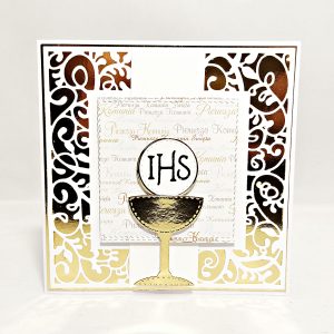 Ręcznie robiona kartka komunijna 13,5x13,5 w biało-złotej kolorystyce z motywem kielicha i IHS, eleganckie zdobienia i delikatne komunijne tło